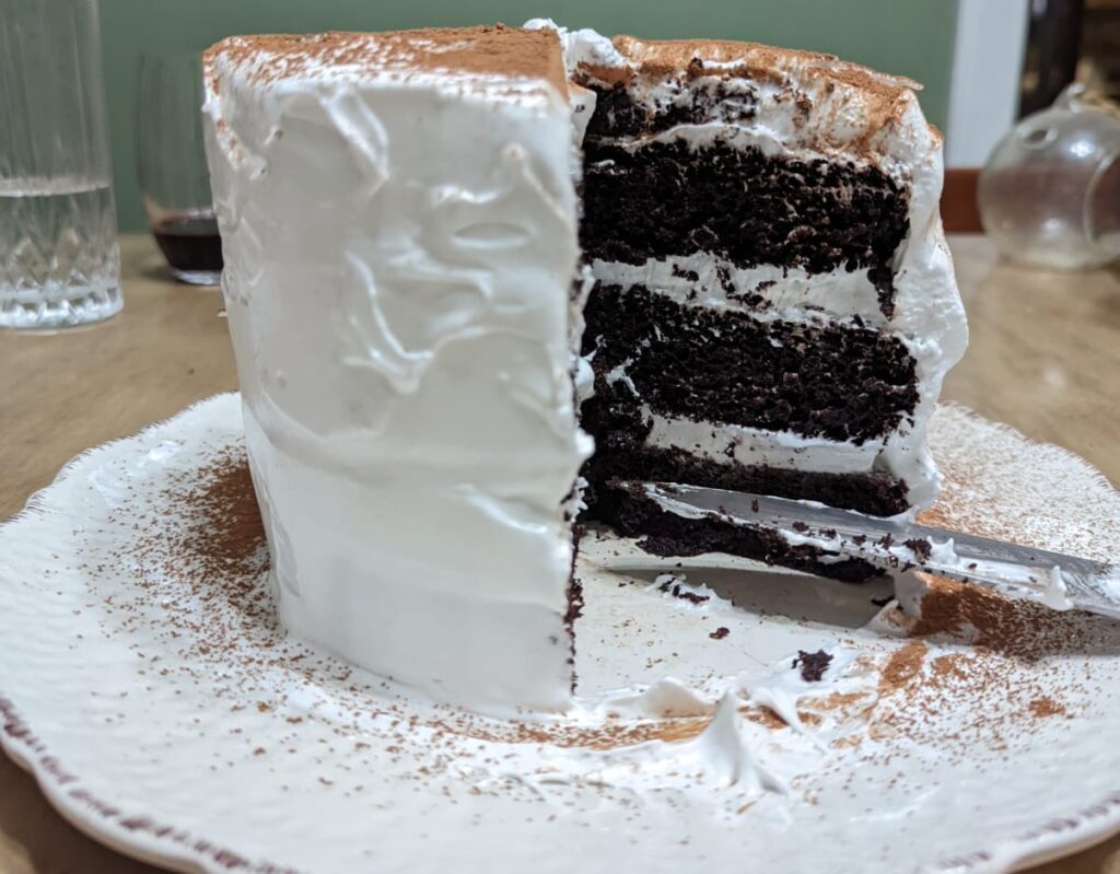 Gluten-free chocolate cake with italian meringue icing