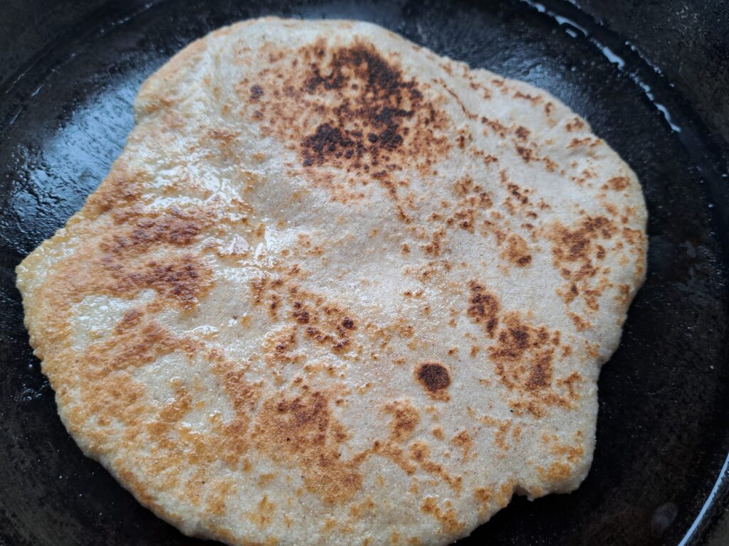 Gluten-free sourdough discard flatbread, cooking in cast iron pan